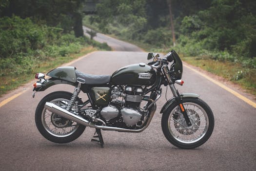 Captured on a tranquil road, a Triumph Thruxton motorcycle promises an adventurous ride.